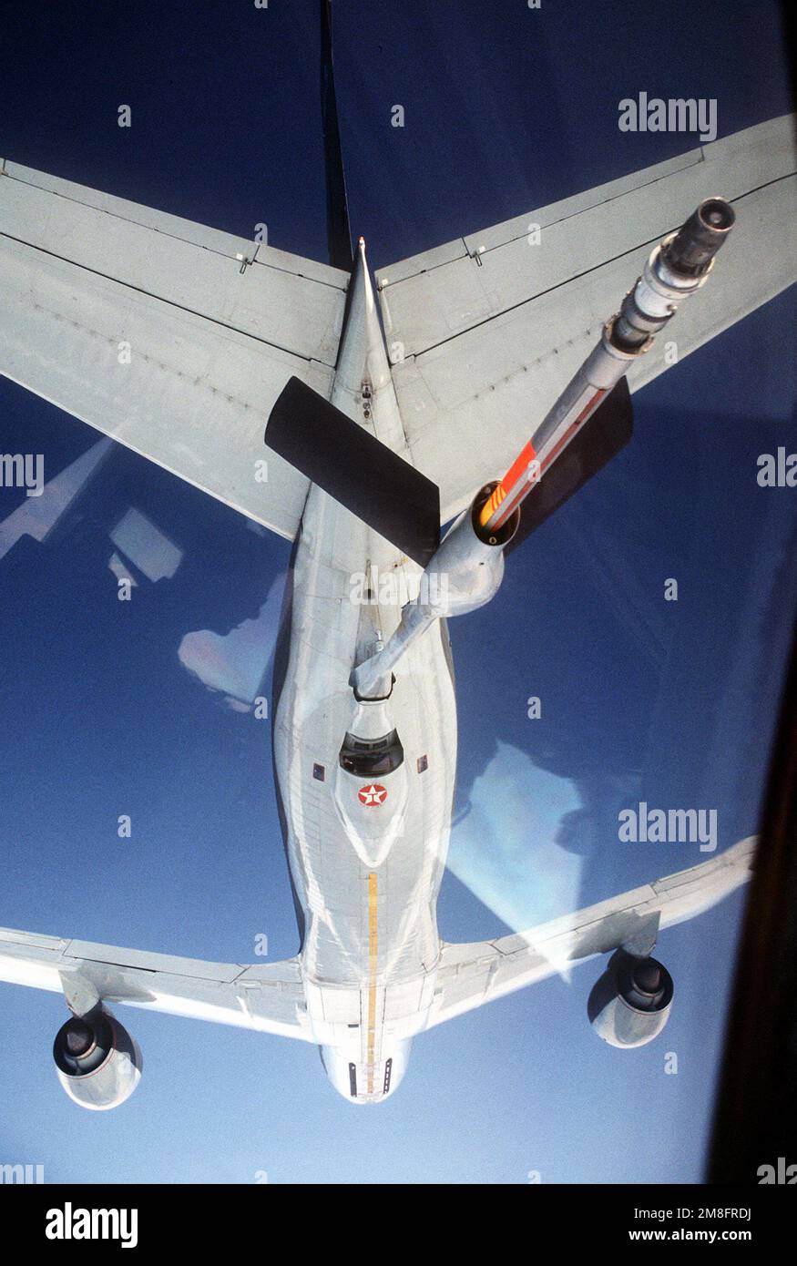 The refueling boom of a 306th Air Refueling Squadron KC-135R Stratotanker aircraft nears a 6th Air Refueling Squadron KC-10A Extender aircraft during a Military Airlift Command channel cargo mission. Country: Unknown Stock Photo