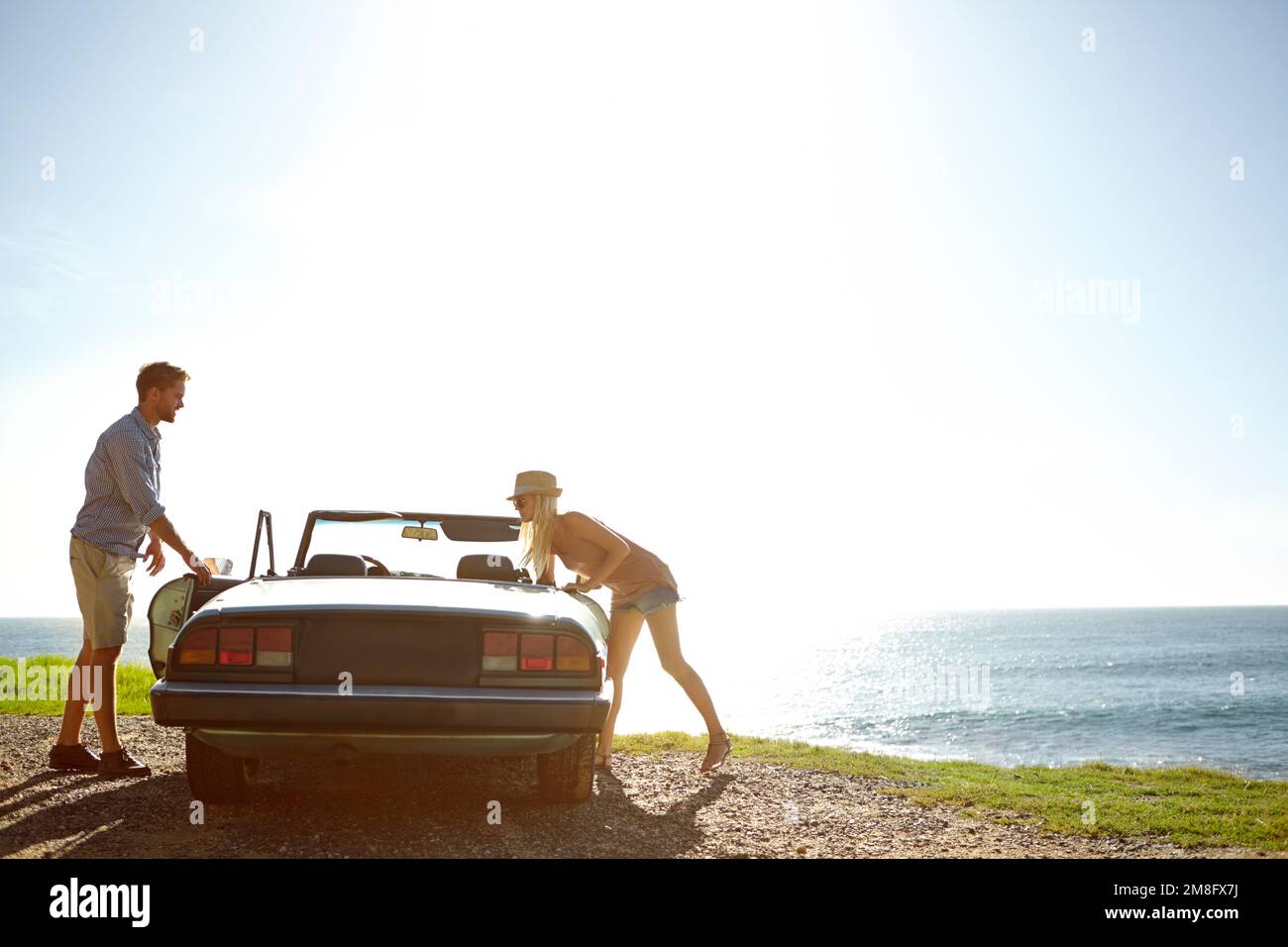 Car road trip, travel and couple on ocean sea adventure, holiday transport journey or summer vacation bond. Love flare mockup, convertible vehicle and Stock Photo