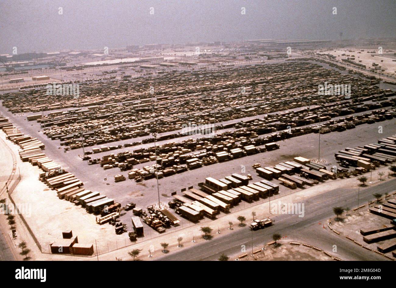 Military vehicles line a holding area near the port of Dammam in preparation for transport back to the United States in the aftermath of Operations Desert Shield/Desert Storm. Subject Operation/Series: DESERT SHIELD DESERT STORM Country: Saudi Arabia (SAU) Stock Photo