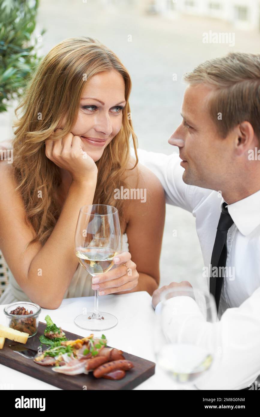 I fall in love eveytime I look into his eyes. A gorgeous couple share a moment in a restaurant. Stock Photo
