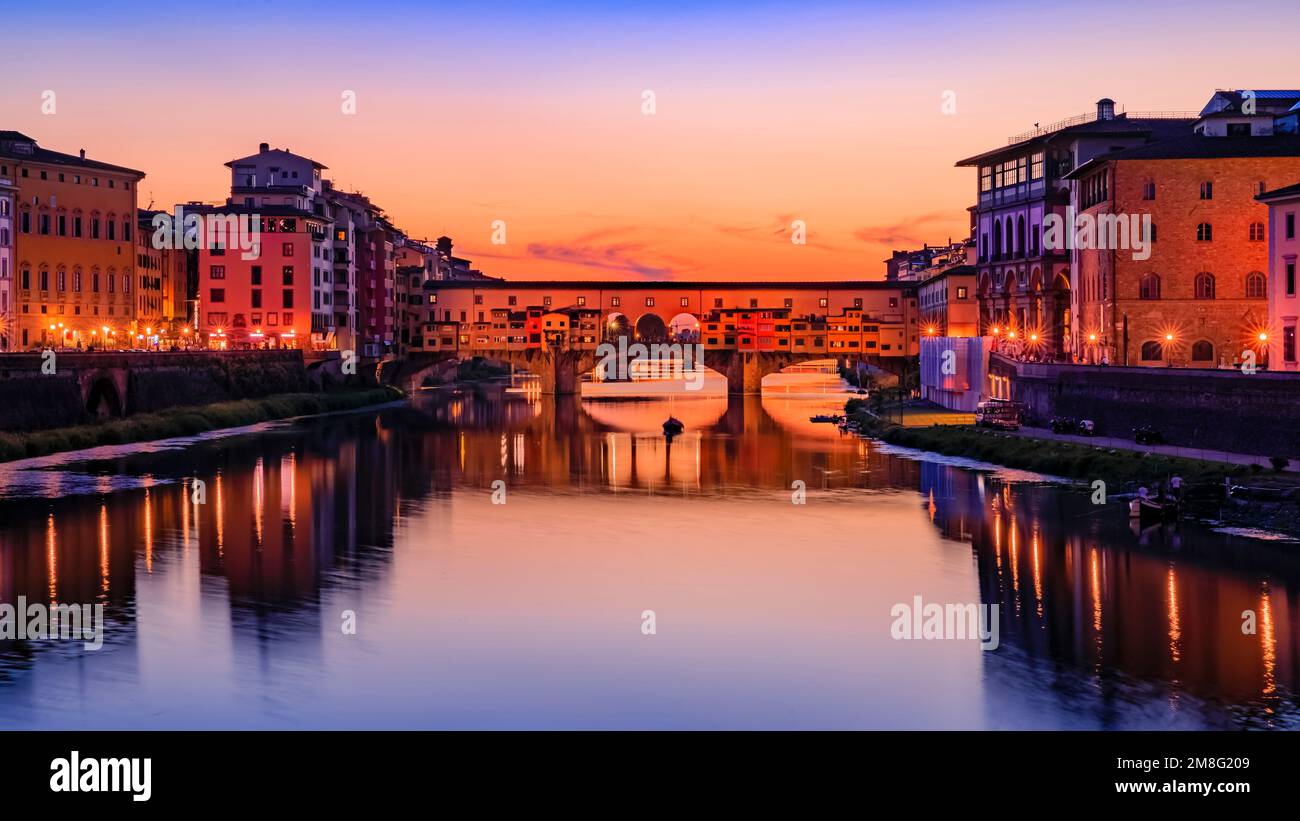 Sunset cityscape with the famous bridge of Ponte Vecchio on the river Arno River in Centro Storico, Florence, Italy Stock Photo