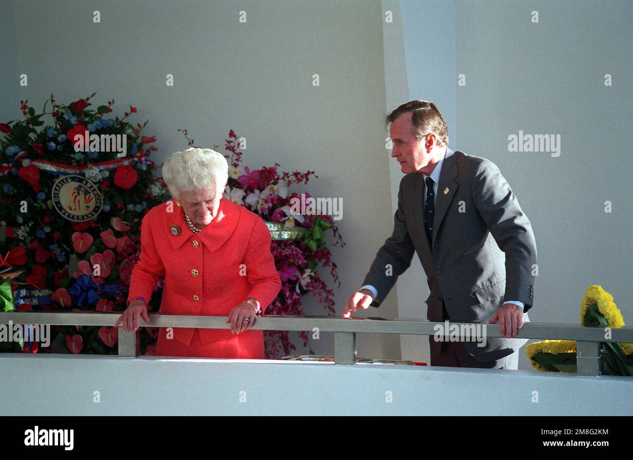 President George Bush and Mrs. Bush stand at the railing of the USS ...