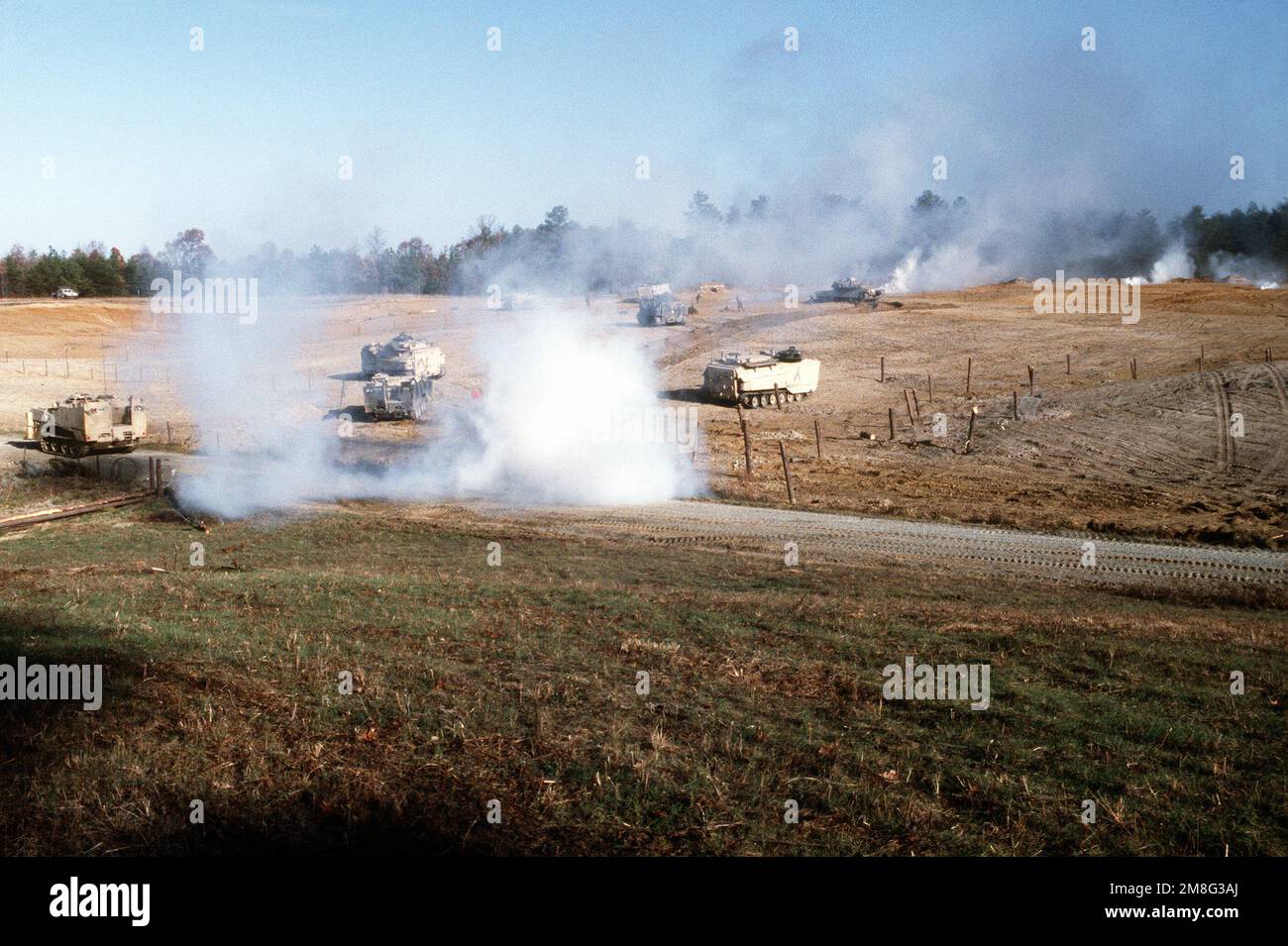 Elements of B Company, 2nd Combat Engineer Battalion (CEB), 2nd Marine Division, advance through a mechanical assault range during a training exercise. The vehicles include two M-9 armored combat earthmovers, four AAV-7A1 amphibious assault vehicles and two M-1A1 Abrams main battle tanks. The two AAV-7A1s in the foreground are fitted with mine clearance kits (MCSKs). Base: Fort A. P. Hill State: Virginia (VA) Country: United States Of America (USA) Stock Photo