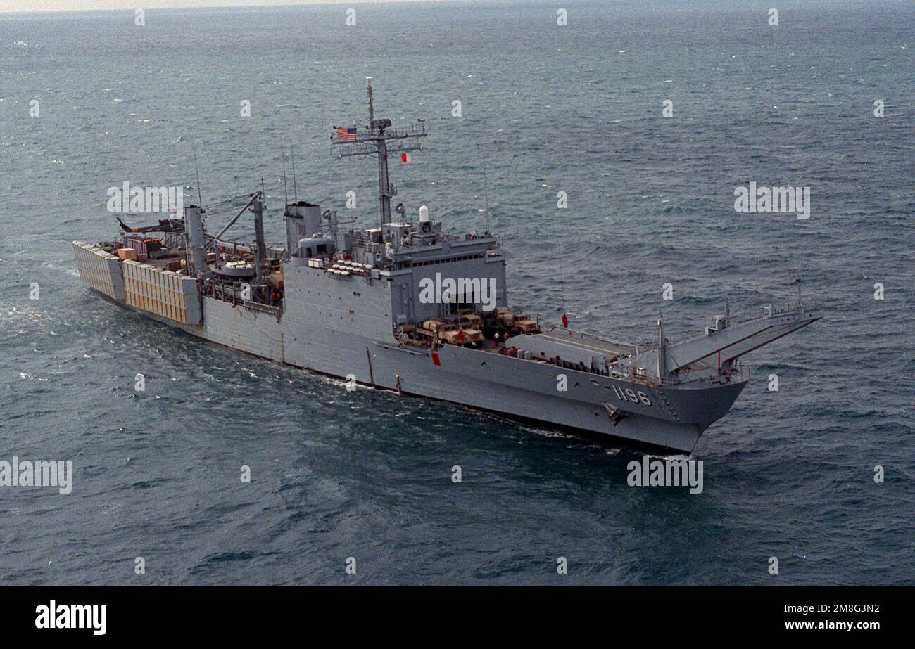 A starboard bow view of the tank landing ship USS HARLAN COUNTY (LST-1196) underway during maritime interdiction operations. Country: Unknown Stock Photo