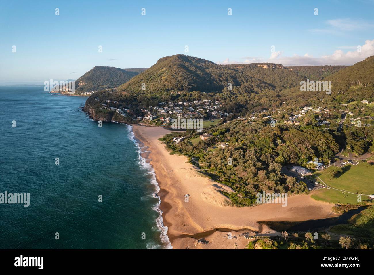A drone shot over green Stanwell park beach on a sunny day Stock Photo