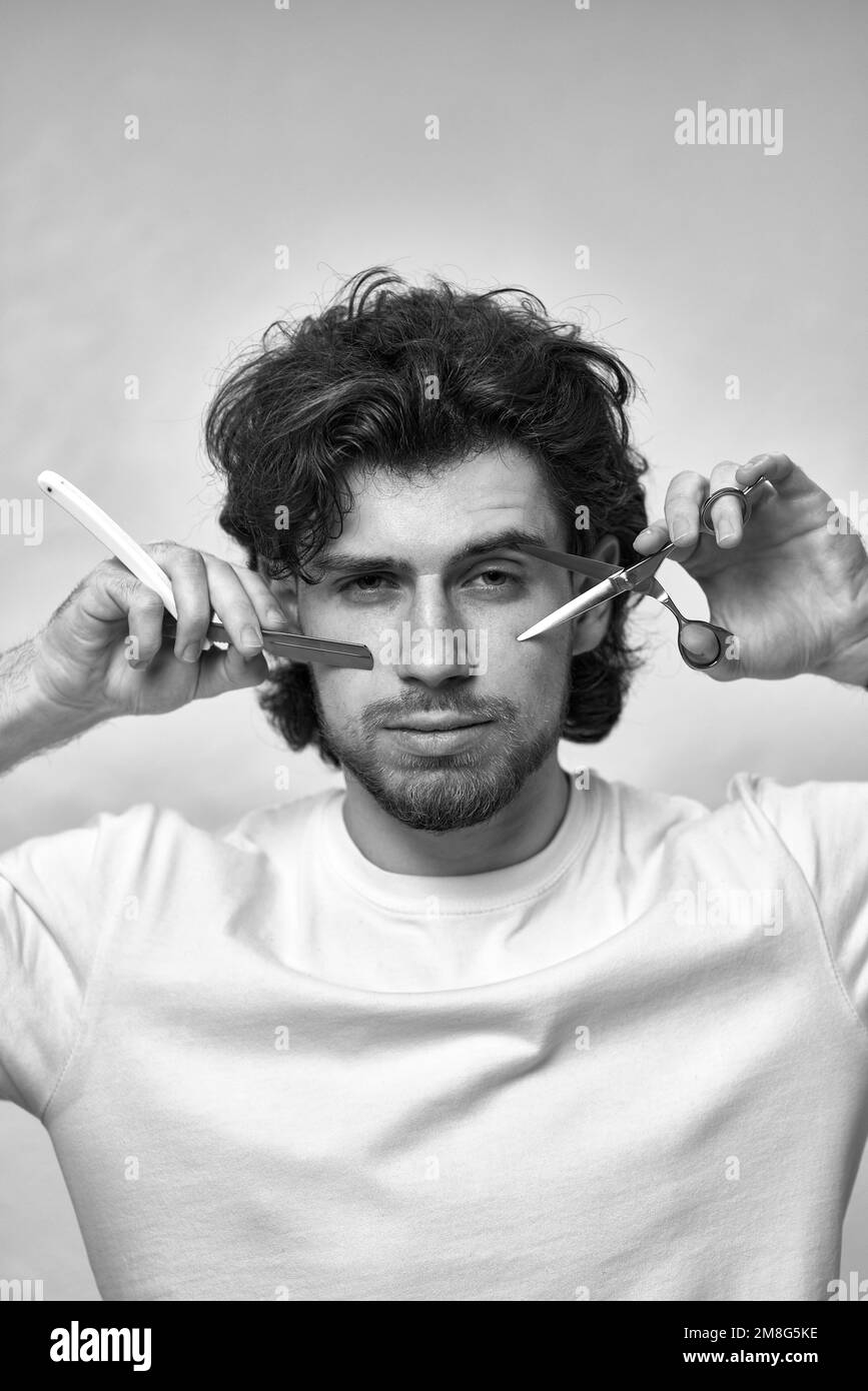 barber testing the sharpness of blade before cutting Stock Photo Alamy