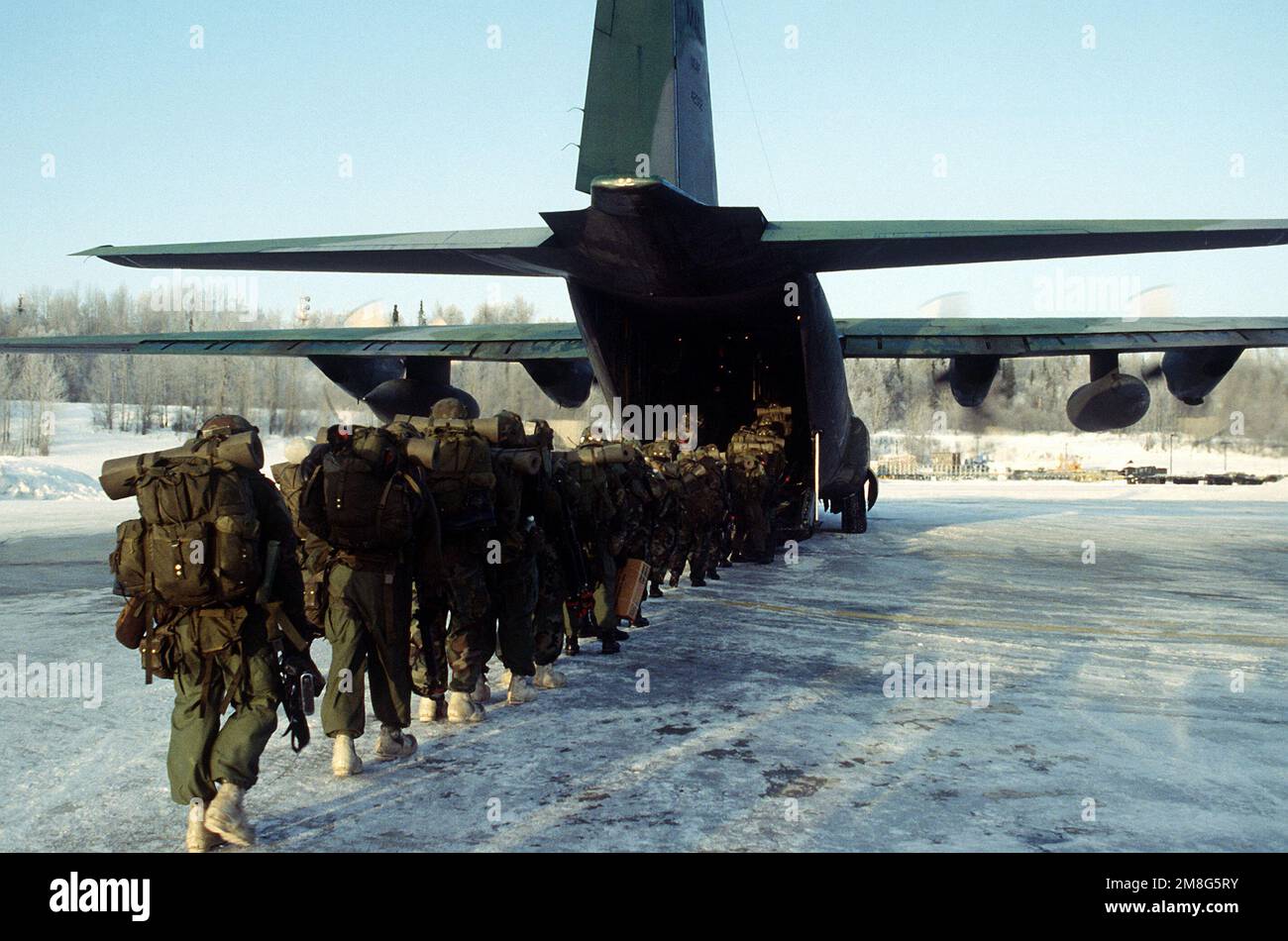 Soldiers from the 2nd Brigade of the 6th Infantry Division (Light), Ft. Wainwright, Alaska, board a C-130 Hercules (17th Tactical Airlift Squadron) for their return flight home during Aurora Tempest 92. Base: Elmendorf Air Force Base State: Alaska (AK) Country: United States Of America (USA) Stock Photo