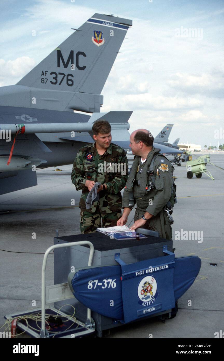 A1C Devin L. Moore, crew chief, left, and LTC Bob Records discuss the condition of a 62nd Tactical Fighter Training Squadron F-16C Fighting Falcon aircraft following a preflight check.. Base: Macdill Air Force Base State: Florida(FL) Country: United States Of America(USA) Stock Photo