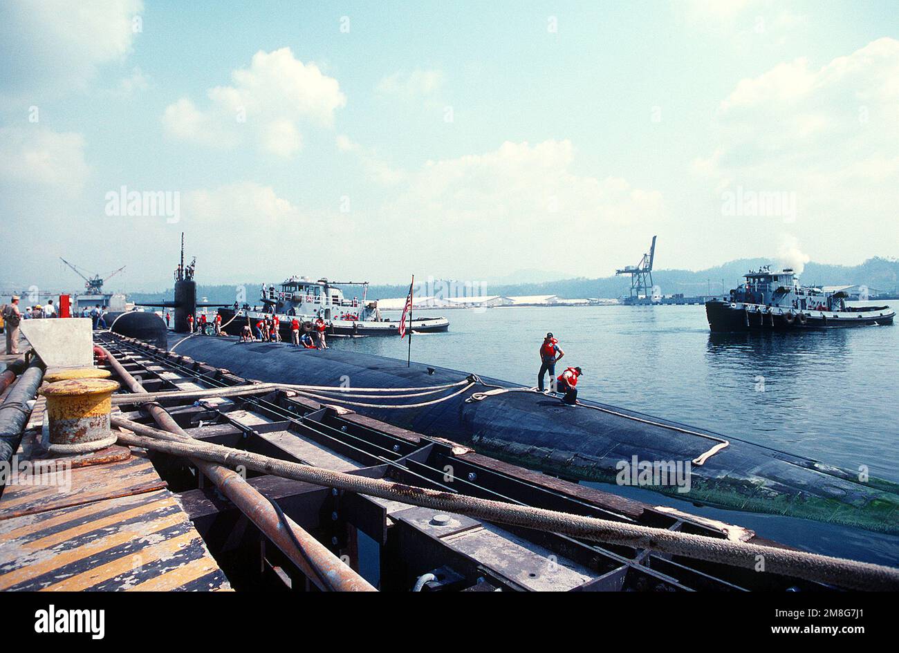 Crew members on the deck of the nuclearpowered attack submarine USS