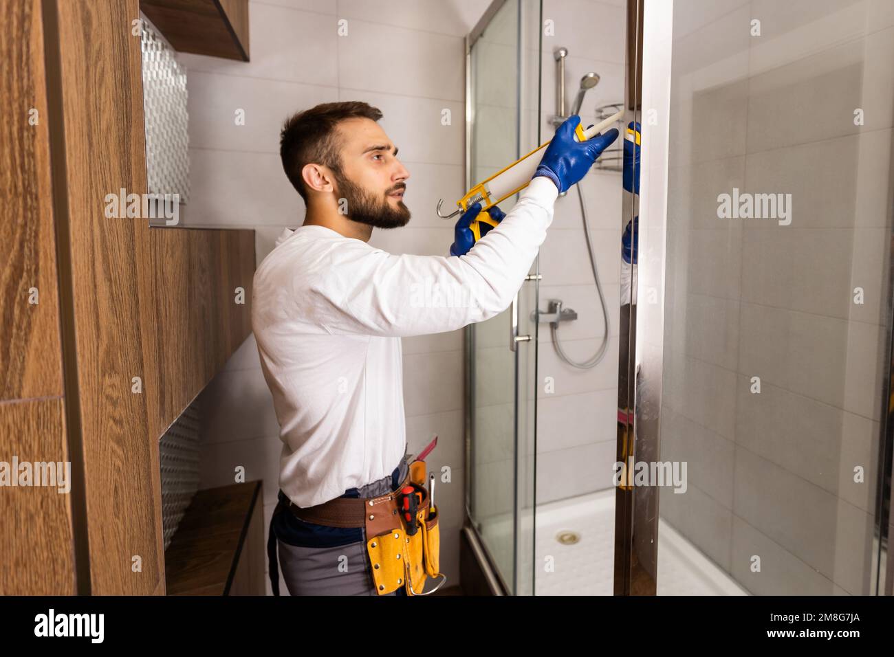 Plumber installing a shower cabin in bathroom Stock Photo Alamy