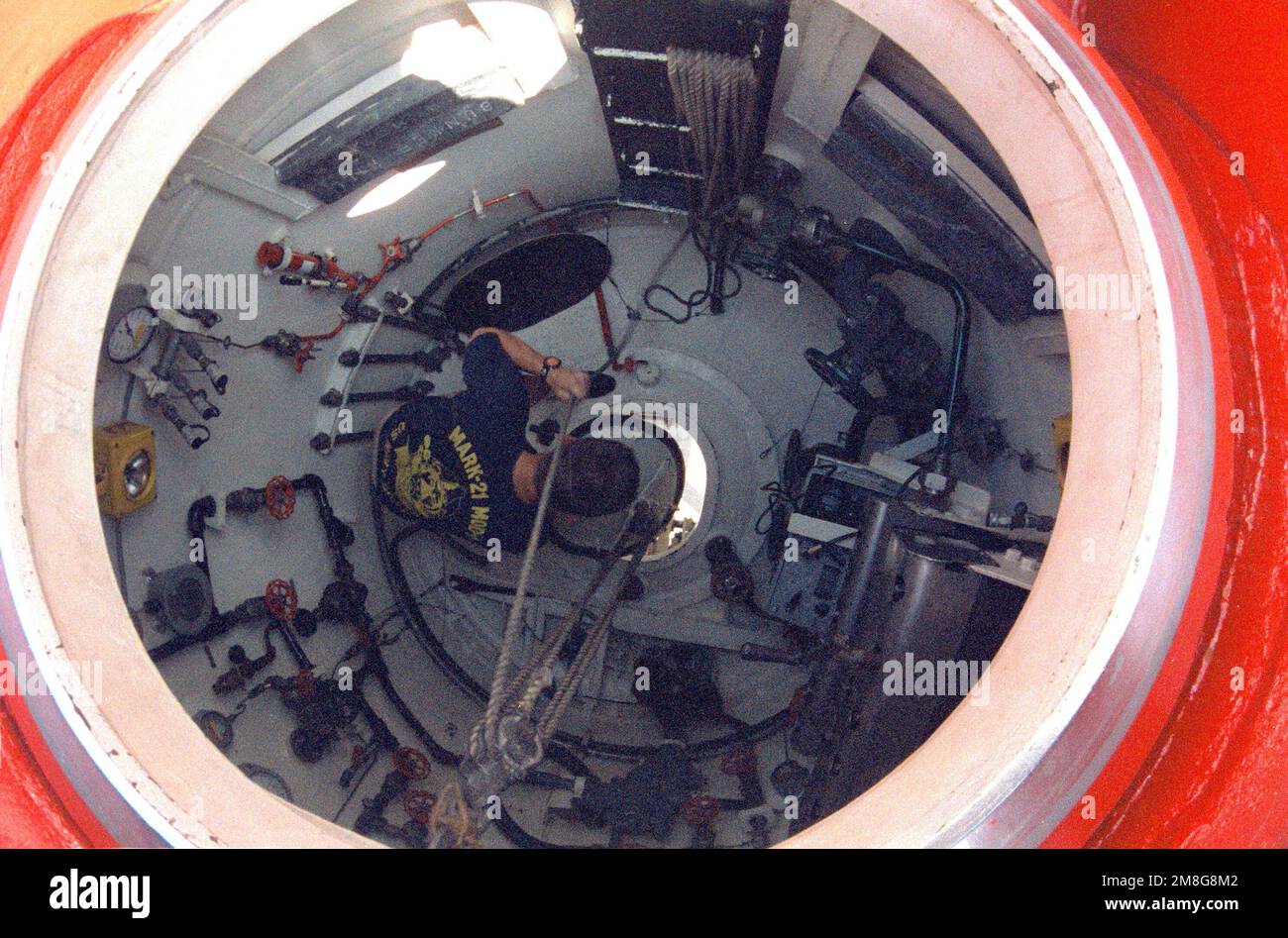Machinery Repairman 2nd Class (Diver) Tim Ross checks the spool inside the submarine rescue chamber of the deep submergence vehicle TURTLE (DSV-3) during the exhibit of the vehicle at Sea World. Base: San Diego State: California(CA) Country: United States Of America (USA) Stock Photo