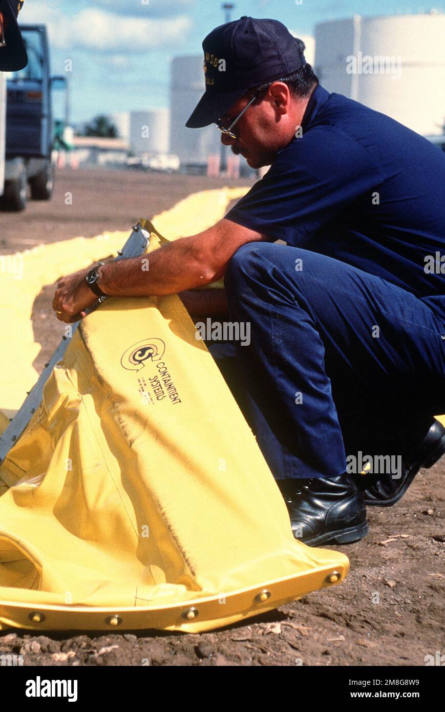 A member of the Coast Guard Marine Safety Office, Honolulu, helps to