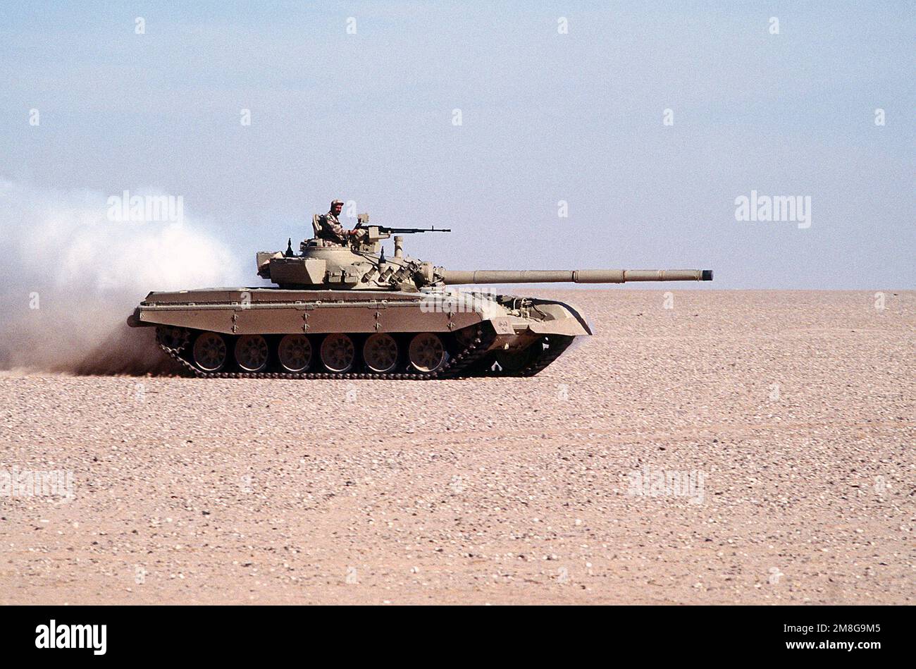 A Kuwaiti M-84 main battle tank lays a smoke screen during a capabilities demonstration at a Kuwaiti outpost during Operation Desert Shield.. Subject Operation/Series: DESERT SHIELD Country: Saudi Arabia(SAU) Stock Photo