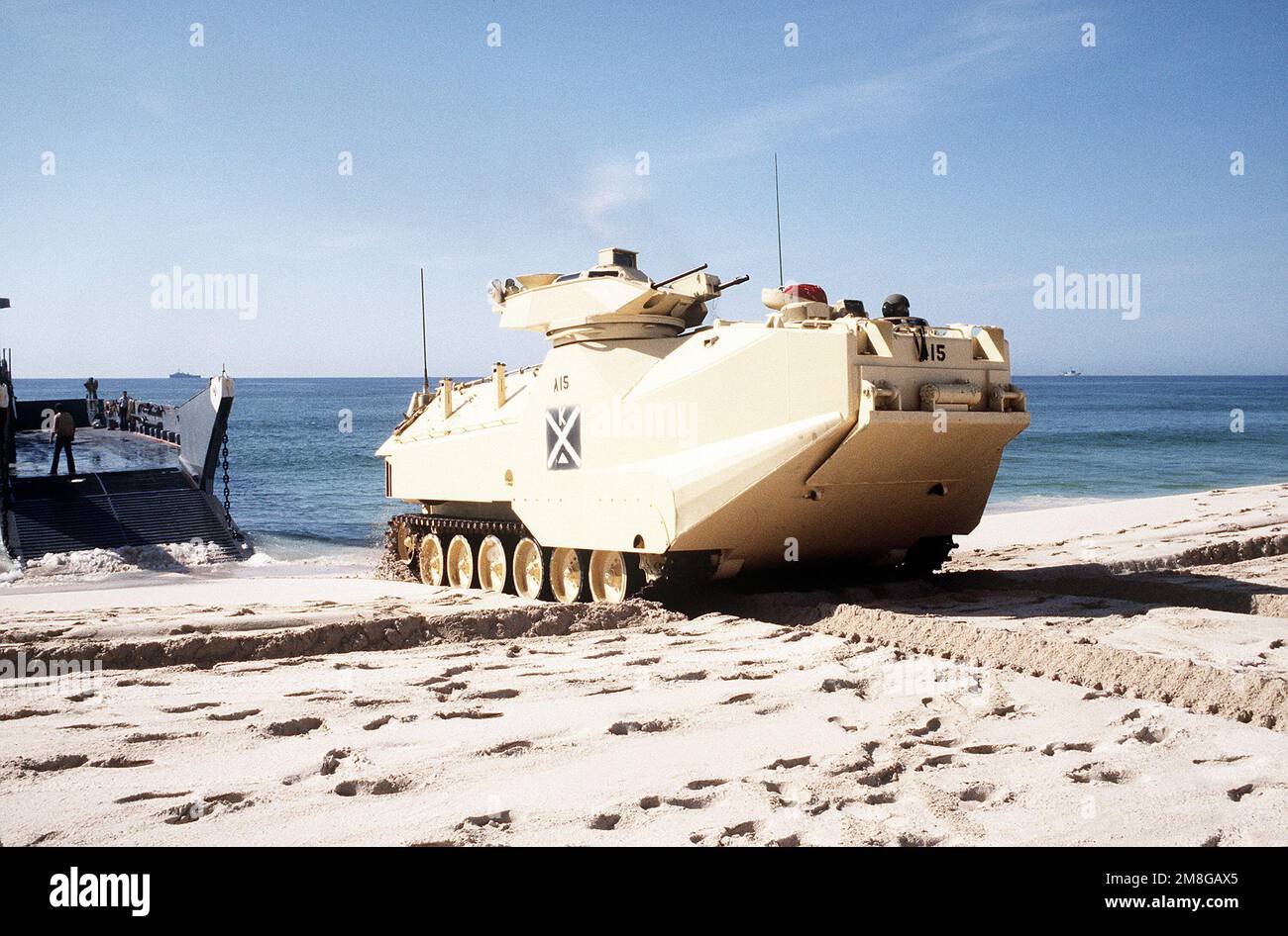 An AAV-7A1 amphibious assault vehicle is driven off a utility landing craft from the amphibious assault ship USS NASSAU (LHA-4) as Marines from the 4th Marine Expeditionary Brigade train in an amphibious beach assault exercise in the Persian Gulf during Operation Desert Shield. Subject Operation/Series: DESERT SHIELD Country: Unknown Stock Photo
