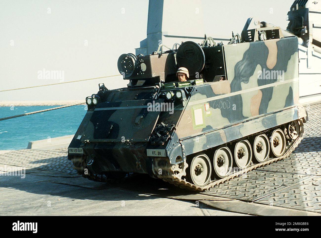 An M-577 armored command post carrier is offloaded from a vehicle cargo ...