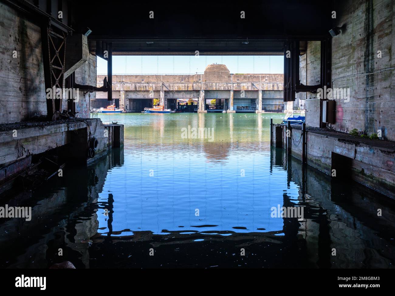The former submarine base seen from the fortified lock, both built by the German army during World War II in Saint-Nazaire, France, on a sunny day. Stock Photo
