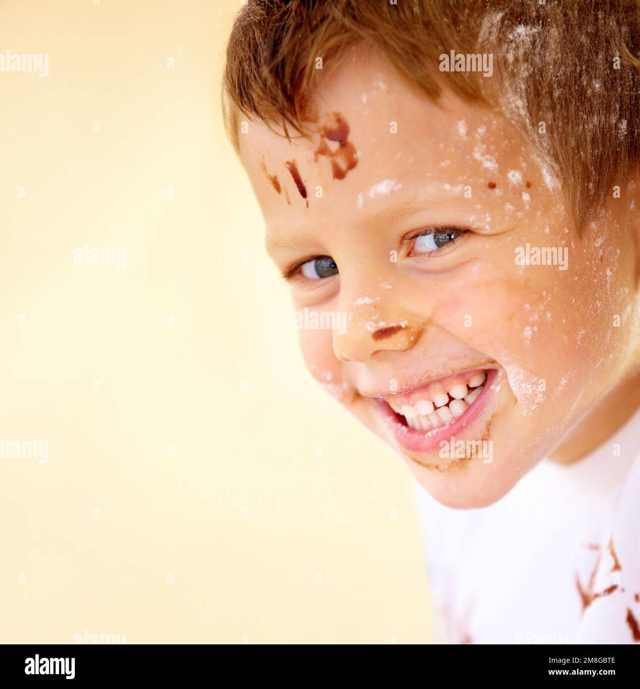 The future of the culinary arts. A little boy covered in dough and