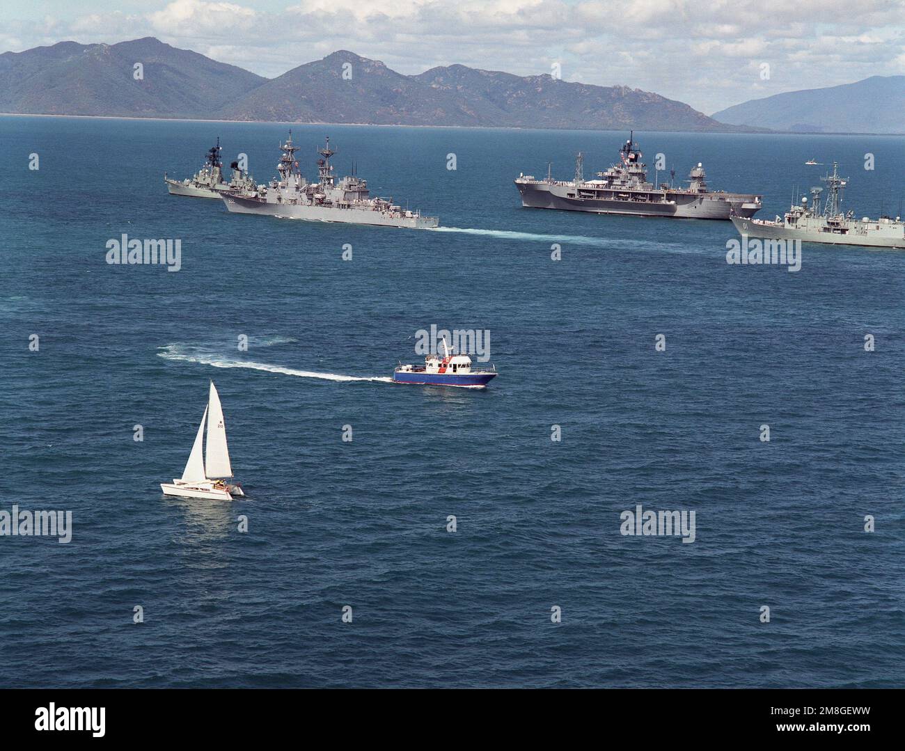 Royal Australian and U.S. Navy ships sail in formation off the coast of ...