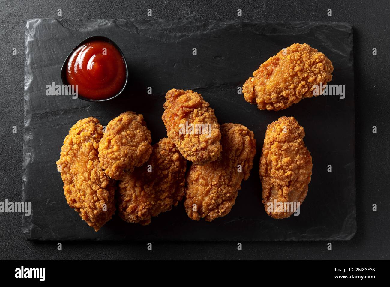 Kurkuri paneer snacks or Crispy Cottage Cheese Bars, served with tomato