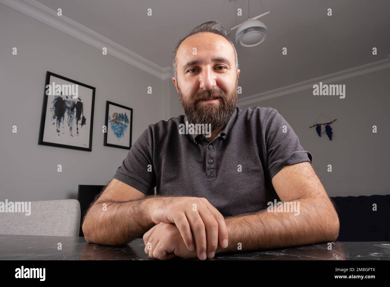 Portrait of smiling employee at home video call. Client or costumer online meeting concept. Web cam view looking camera. Freelance businessman. Stock Photo
