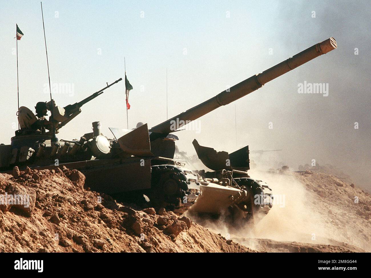 A Kuwaiti M-84 main battle tank crosses a trench during a capabilities demonstration at a Kuwaiti outpost during Operation Desert Shield.. Subject Operation/Series: DESERT SHIELD Country: Saudi Arabia(SAU) Stock Photo