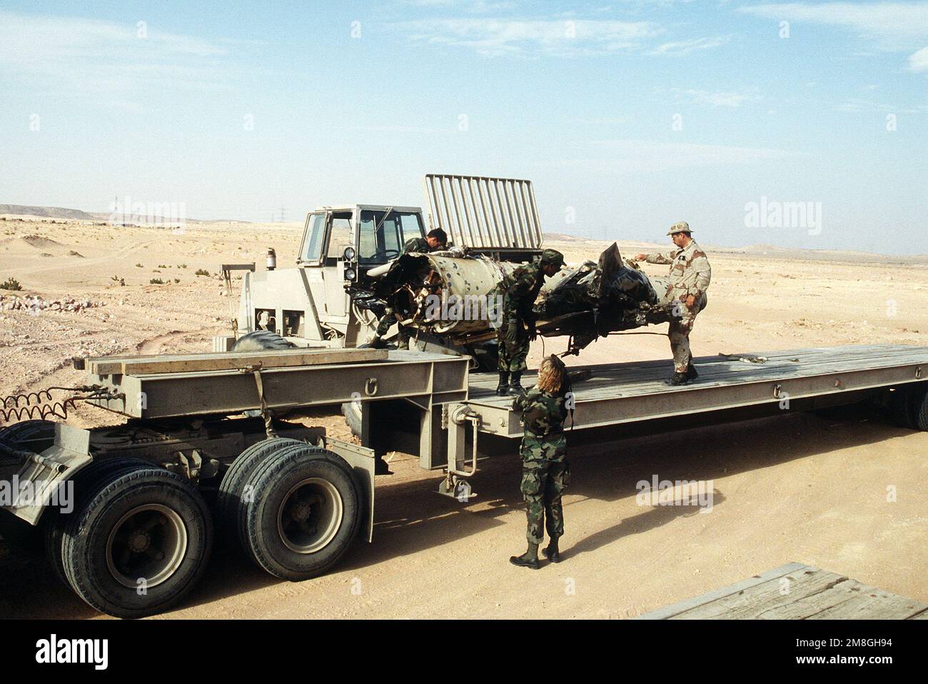 Military personnel transfer a Scud missile, shot down in the desert by ...