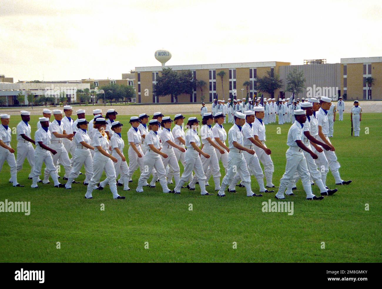 Members of th e chorus of a co-ed recruit company pass in review during their graduation ceremony. Recruit Training Command, Orlando, is the only Navy command where both men and women undergo basic training. Base: Naval Training Center, Orlando State: Florida(FL) Country: United States Of America (USA) Stock Photo