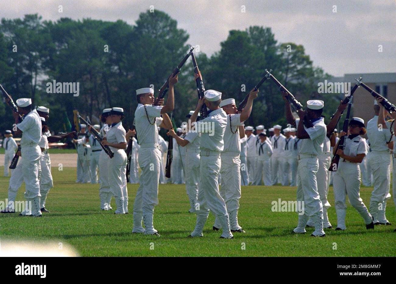 A drill team, part of a co-ed recruit company, performs during their unit's graduation ceremony at the Naval Training Center. Recruit Training Command, Orlando, is the only Navy command where both men and women undergo basic training. Base: Naval Training Center, Orlando State: Florida(FL) Country: United States Of America (USA) Stock Photo