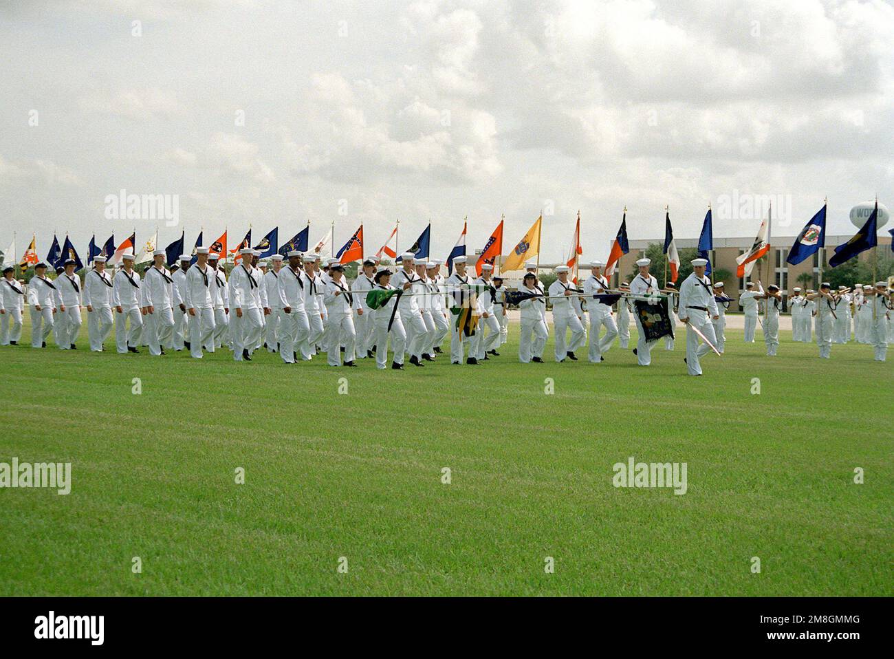 Members of a co-ed recruit company pass in review during their graduation ceremony. Recruit Training Command, Orlando, is the only Navy command where both men and women undergo basic training. Base: Naval Training Center, Orlando State: Florida(FL) Country: United States Of America (USA) Stock Photo