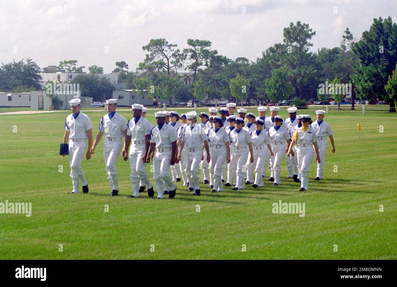 Members of the chorus of a co-ed recruit company pass in review during their graduation ceremony. Recruit Training Command, Orlando, is the only Navy command where both men and women undergo basic training. Base: Naval Training Center, Orlando State: Florida(FL) Country: United States Of America (USA) Stock Photo