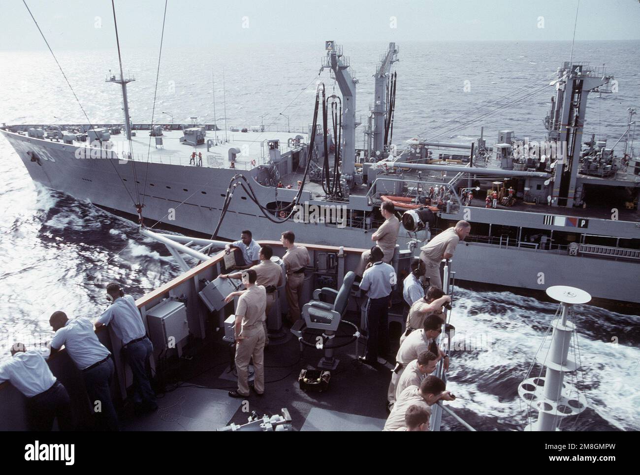 Officers and crewmen on the starboard bridge wing of the amphibious ...