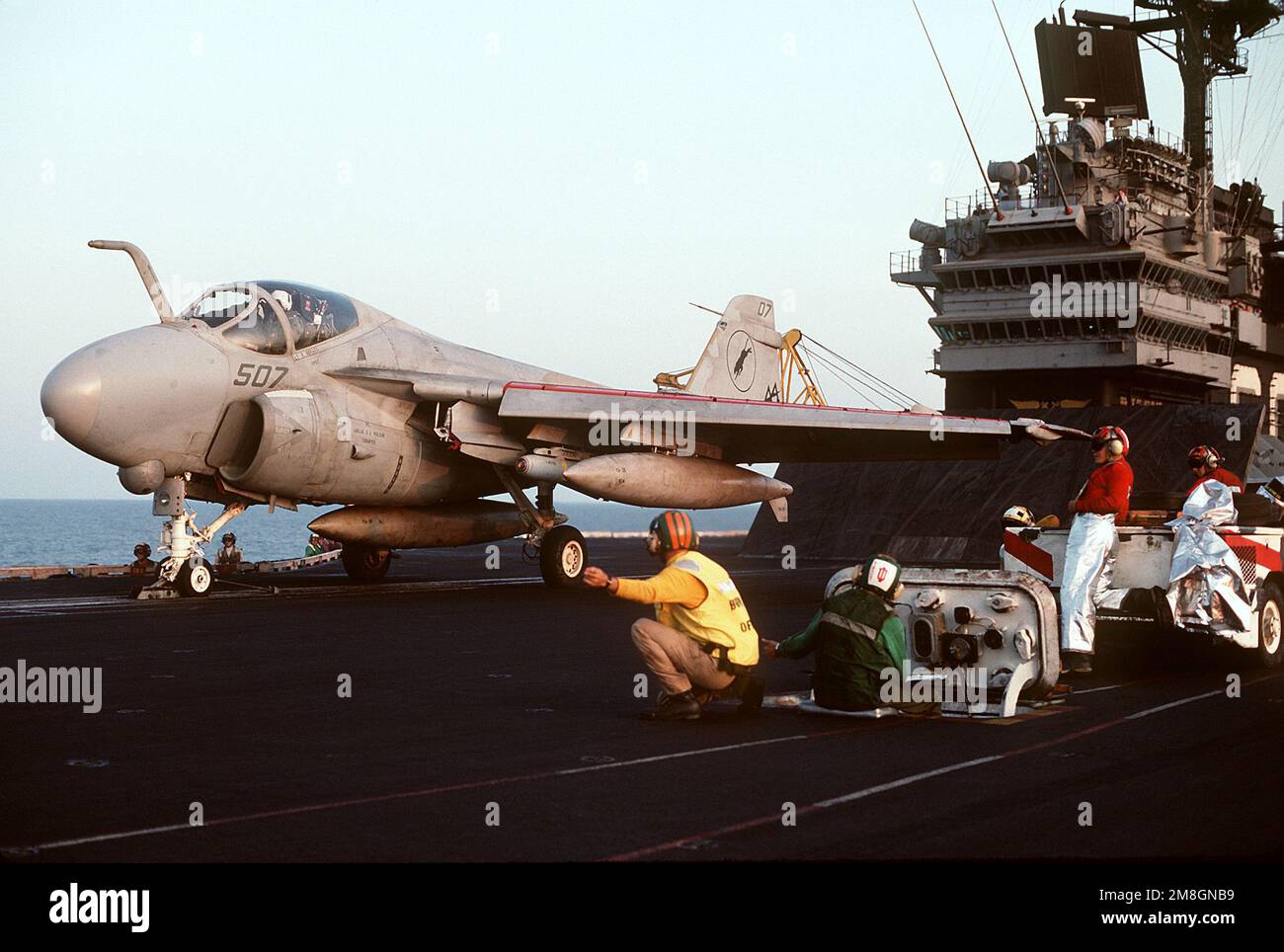 The catapult officer gives the launch signal to the pilot of an Attack Squadron 35 (VA-35) A-6E Intruder aircraft on the starboard catapult of the aircraft carrier USS SARATOGA (CV-60). An AGM-65E Maverick missile is mounted on the port, inboard wing pylon. Base: USS Saratoga (CV 60) Country: Mediterranean Sea (MED) Stock Photo