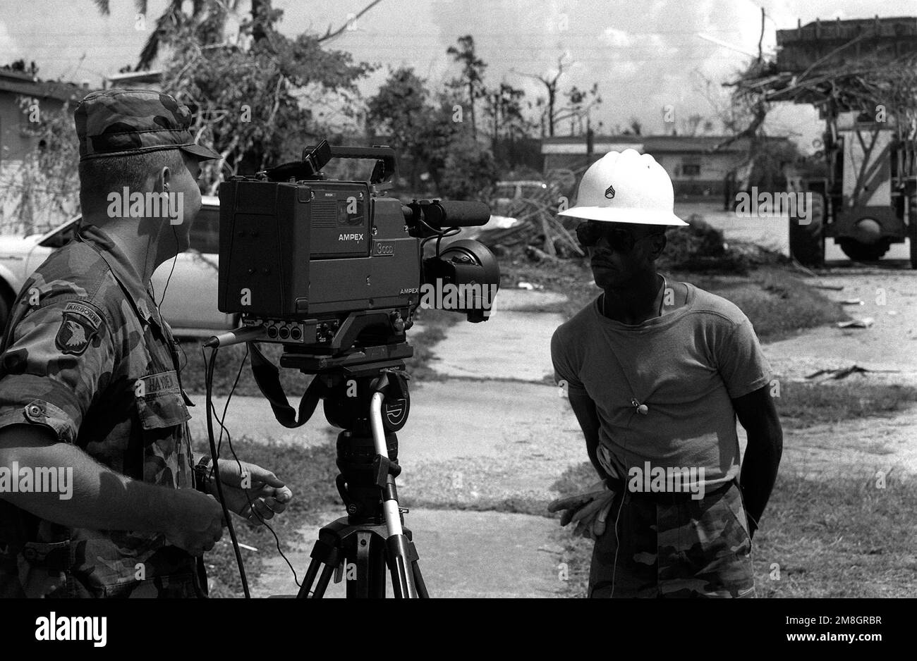 Army SGT Bennie Hayden, Combat Pictorial Detachment, Fort Meade, Maryland, interviews SSG Edgar Dixon, from the 46th Engineer Battalion, Fort Rucker, about the damages incurred by the small town near the base as a result of Hurricane Andrew. Base: Homestead Air Force Base State: Florida (FL) Country: United States Of America (USA) Stock Photo