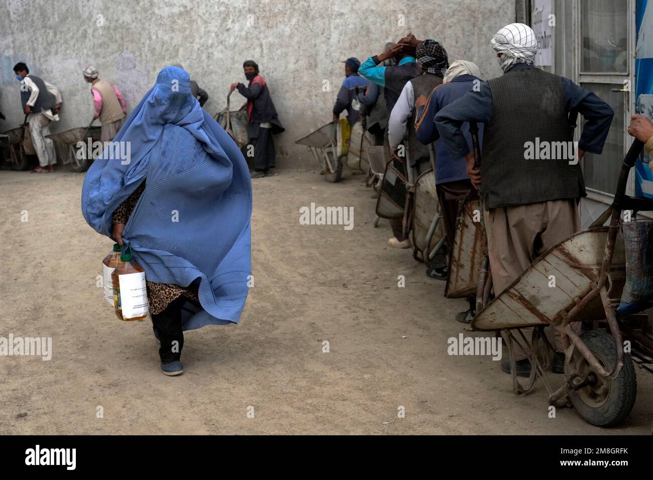 Humainitarian Aid Ration FILE - An Afghan woman receives a food ration distributed by a South ...