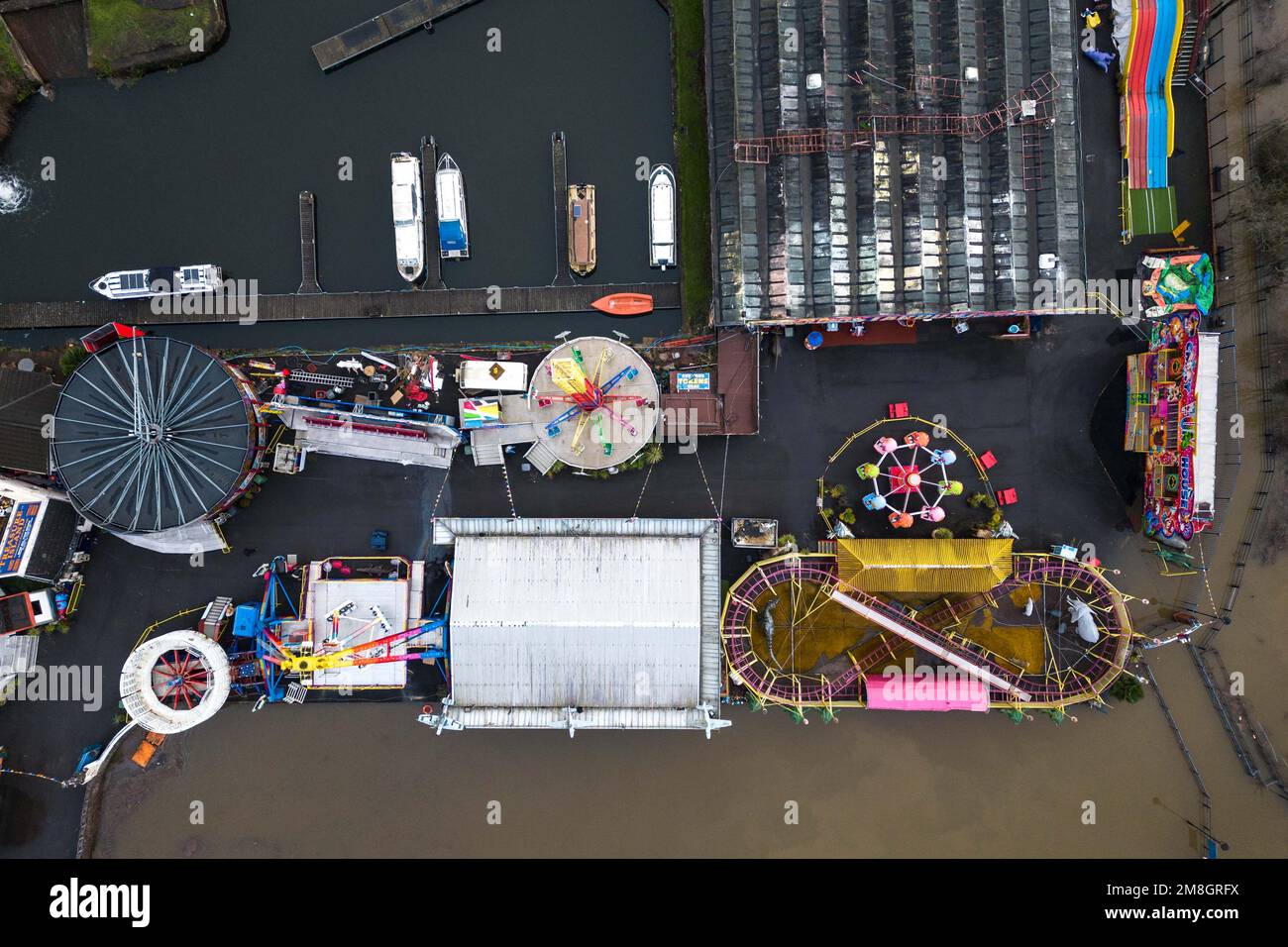 Stourport on Severn, Worcestershire, January 14th 2023 - A fairground has been cut off by rising flood water after the River Severn burst its banks in Stourport on Severn. Also spotted was a life size dinosaur that was just managing to keep itself above water as the river levels completely flooded the Playland mini golf course in the Riverside Meadows Park. The dinosaur, named Dennis, is used by locals to guage the height of the rising floods. The past 3 years it has reached 'chin' level. Credit: Stop Press Media/Alamy Live News Stock Photo