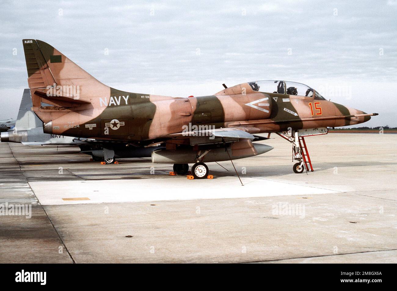 A right side view of a Fighter Squadron 126 (VF-126) TA-4F Skywhawk aircraft parked on the flight line. Base: Naval Air Facility, Andrews Afb State: Maryland (MD) Country: United States Of America (USA) Stock Photo