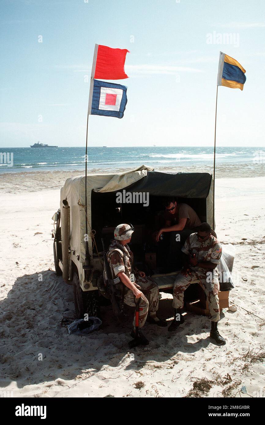U.S. Navy beachmasters relax in an M998 High-Mobility Multipurpose Wheeled Vehicle (HMMWV) during the multinational relief effort Operation Restore Hope. Subject Operation/Series: RESTORE HOPE Base: Mogadishu Country: Somalia (SOM) Stock Photo