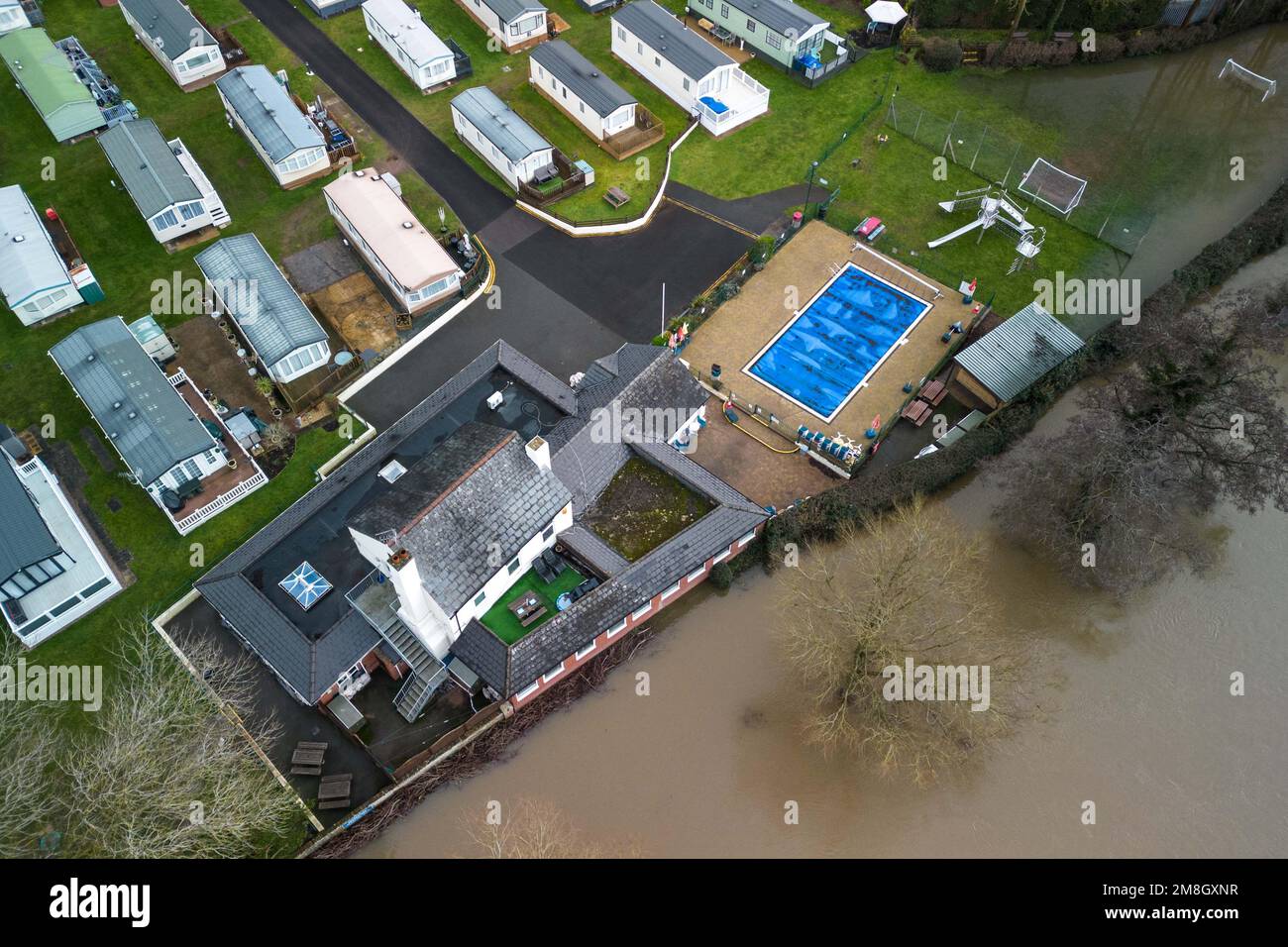 Stourport on Severn, Worcestershire, January 14th 2023 - Caravan sites along the River Severn in Stourport on Severn have been flooded due to the rising flood water after the river burst its banks. A row of riverside houses and a parks leisure pool are kept dry due to flood barriers and water pumps. The river is expected to rise further and peak early on Sunday morning. Credit: Stop Press Media/Alamy Live News Stock Photo