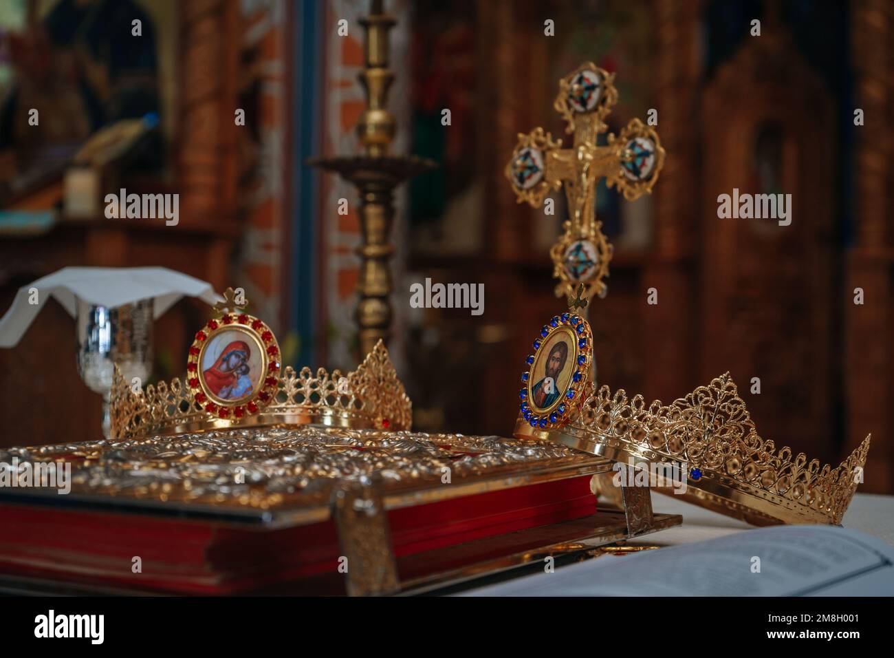 The golden crowns used for christian rituals with a cross on the ...