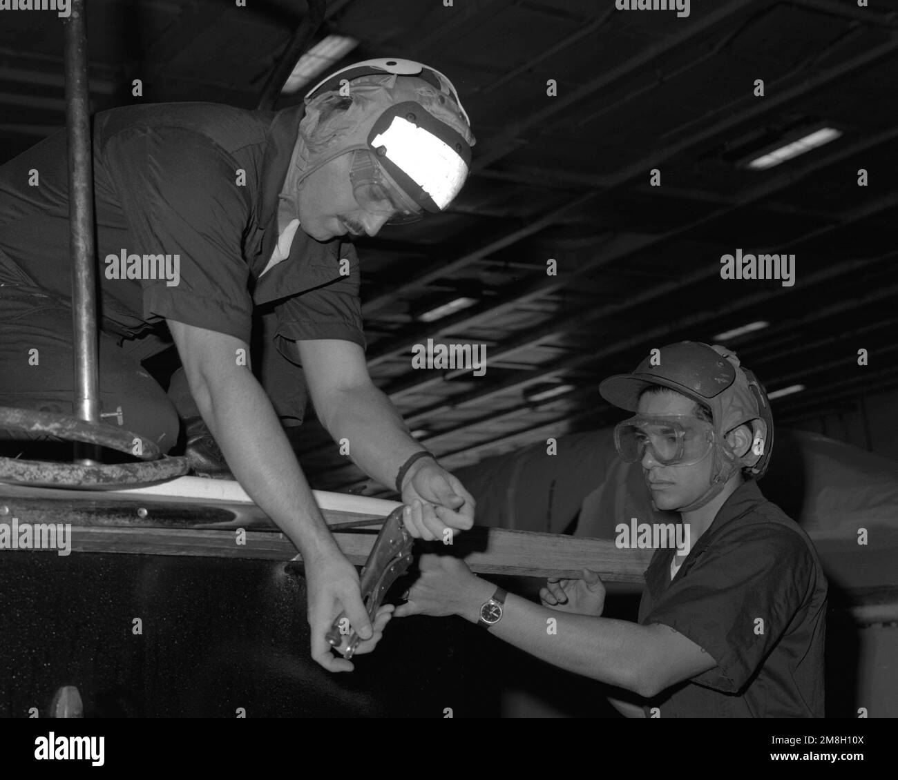 Boatswain's Mate 2nd Class Jim Hill, left, and Boatswain's Mate SEAMAN