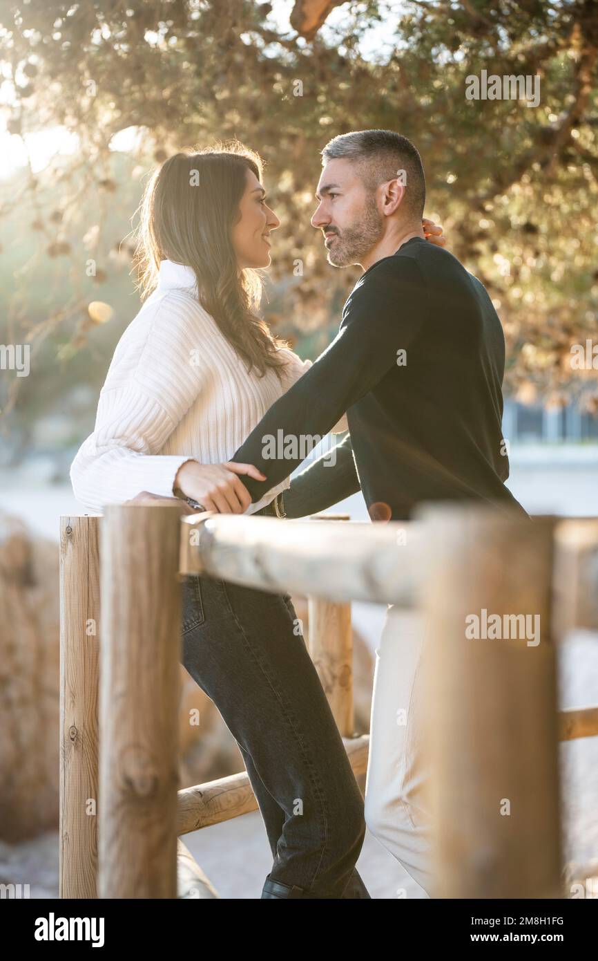 Romantic scene with a heterosexual couple looking each other  Stock Photo
