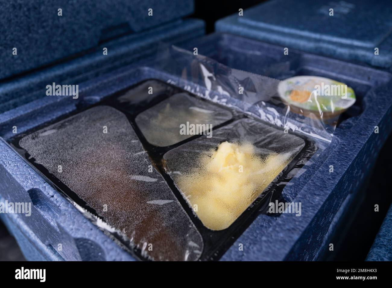 Hot meal packed in a plastic and polystyrene boxes to be delivered to
