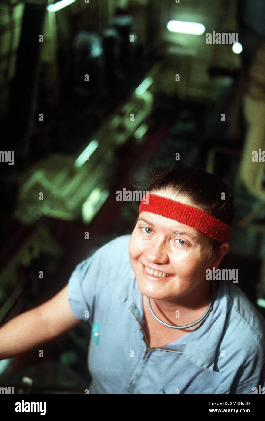 An informal portrait of 41 year old Cloda 'Charlie' Kelley, a former U.S. Navy Corpsman, working in the engine room of the Military Sealift Command prepostioning ship PVT. FRANKLIN J. PHILLIPS (T-AK-3013). Charlie served five years in the U.S. Navy before shipping over to the U.S. Merchant Marine Service. Country: Somalia (SOM) Stock Photo