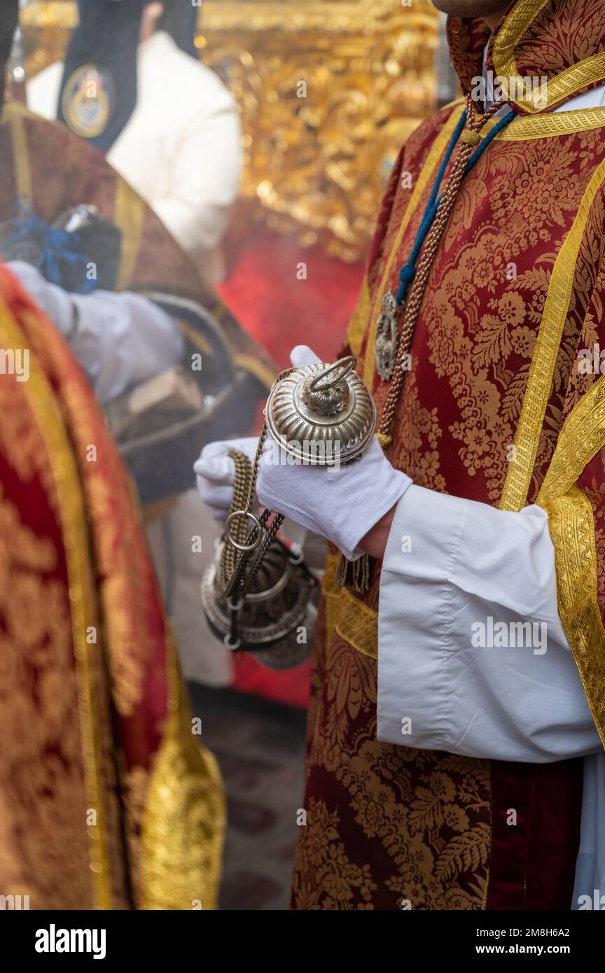 People in traditional dress weraing a capriote, or pointed hat in an Easter Parade during Holy Week or Semana Santa in Cadiz, Spain Stock Photo