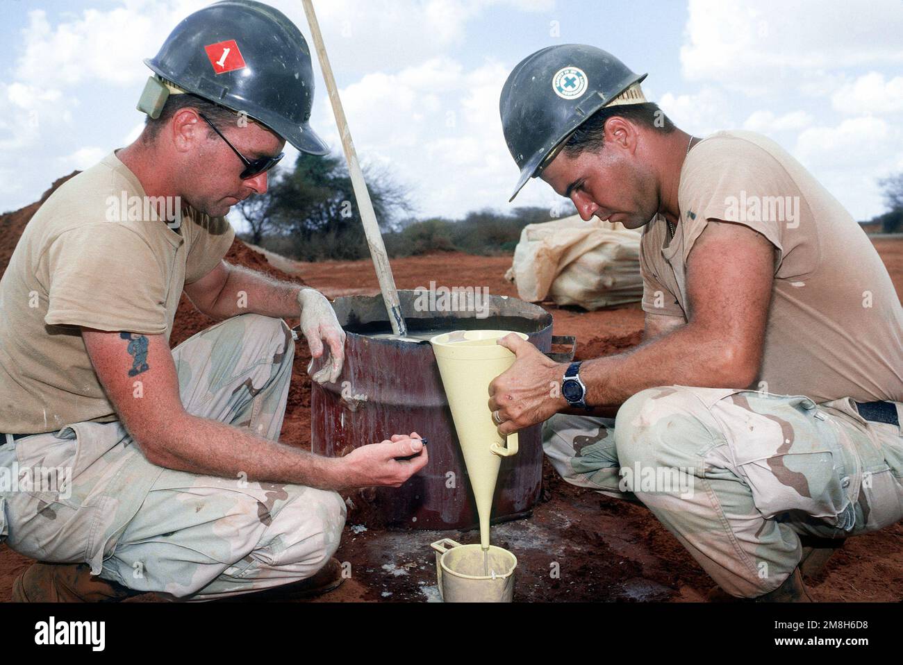 While working on a water well drilling project, members of Naval Mobile Construction Battalion 1 (NMCB-1) time how fast a sample empties from a funnel to determine the viscosity of the sample. The well, near Bale Dogle, is intended to supply an old Soviet air base being used by U.S. and Moroccan personnel participating in the operation. Subject Operation/Series: RESTORE HOPE Country: Somalia (SOM) Stock Photo