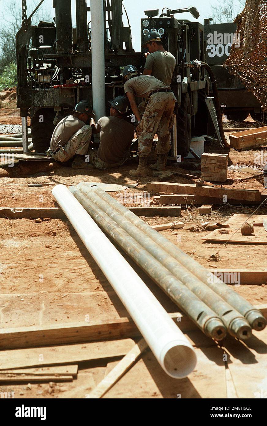 Members of Naval Mobile Construction Battalion 1 (NMCB-1) work on a mobile drilling rig being used to drill a water well. The well, near Bale Dogle, is intended to supply an old Soviet air base being used by U.S. and Moroccan personnel participating in the multinational relief effort Operation Restore Hope. Subject Operation/Series: RESTORE HOPE Country: Somalia (SOM) Stock Photo