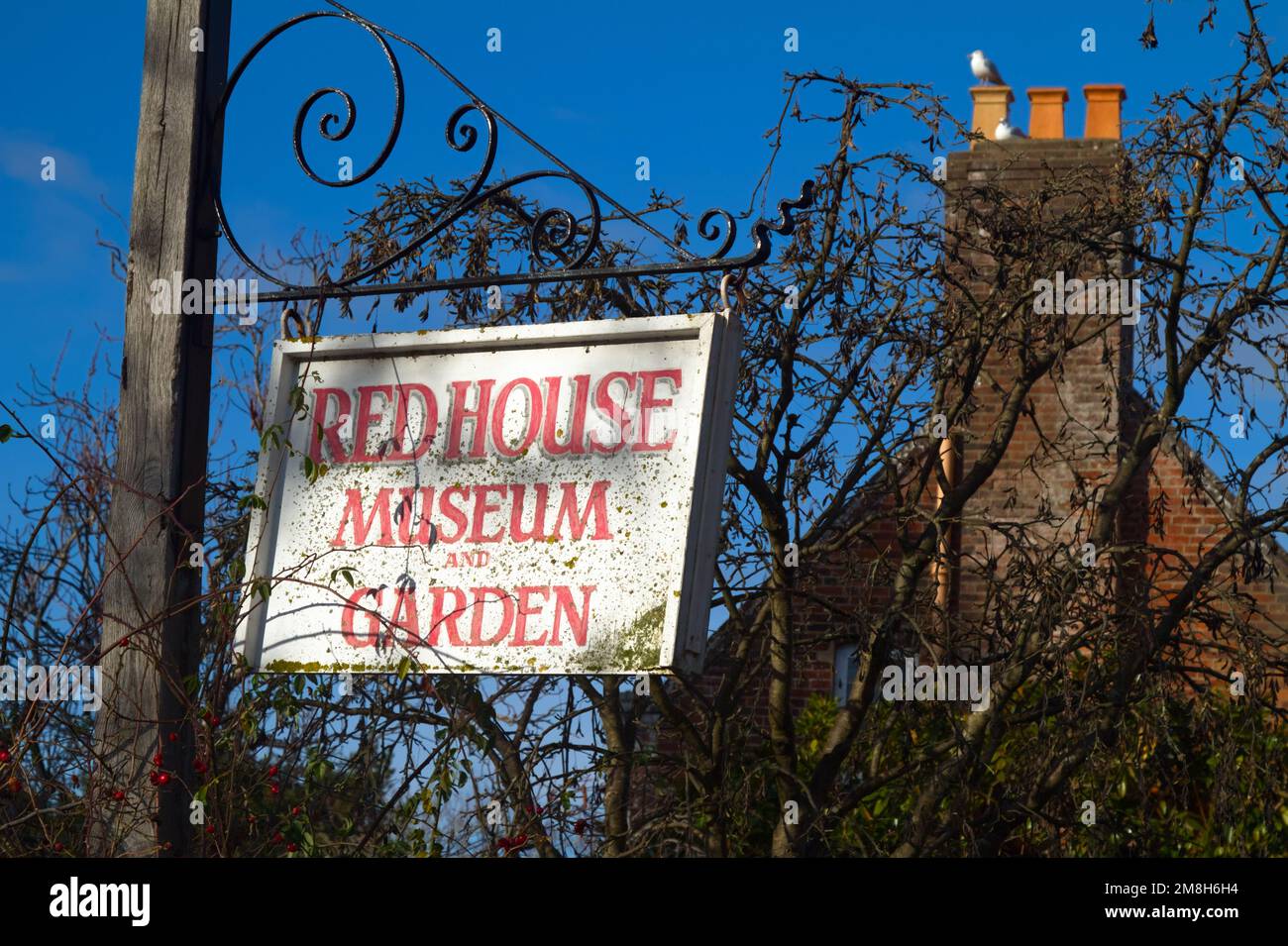 Wooden Sign Hanging On A Wrought Iron Frame Advertising The Red House Museum House And Garden Christchurch UK Stock Photo