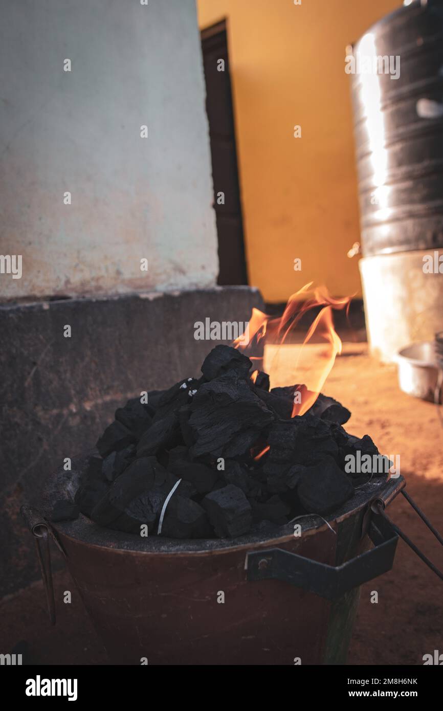 Coal burning in a pot on ground Stock Photo Alamy