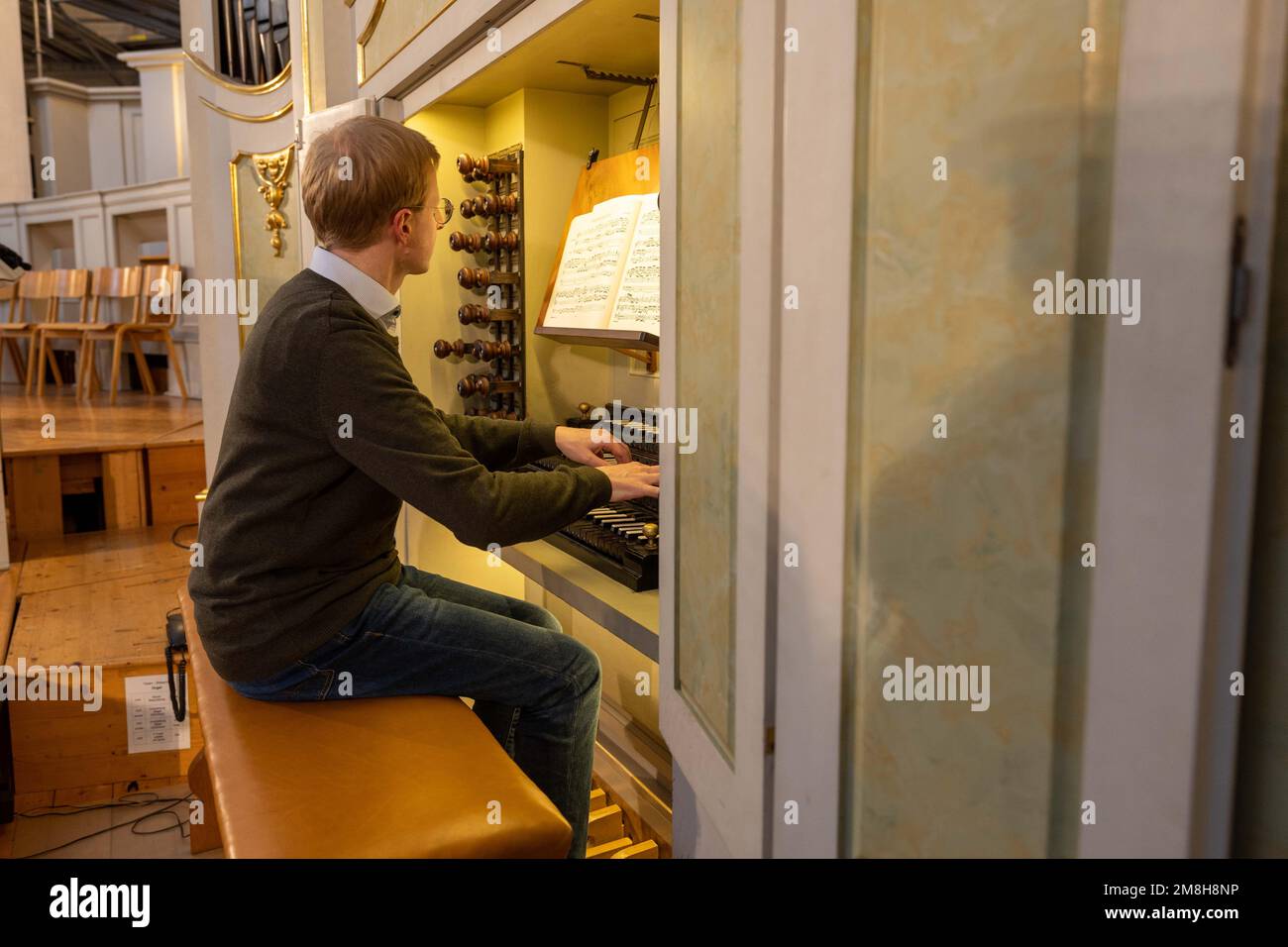 14 January 2023, Saxony, Dresden: Cathedral organist Sebastian Freitag plays the Praeludium et Fuga in C major by Johann Sebastian Bach for the 'Silbermann SoundWalk' on the occasion of the 340th birthday of G. Silbermann on the historic Silbermann organ in the Catholic Court Church in Dresden. For the first time in history, 32 historic Silbermann organs in four German states are to be connected to form a sound network. Throughout the day, all completely preserved Silbermann organs in Saxony, Brandenburg, Thuringia and Bremen will be heard in succession. Photo: Daniel Schäfer/dpa Stock Photo