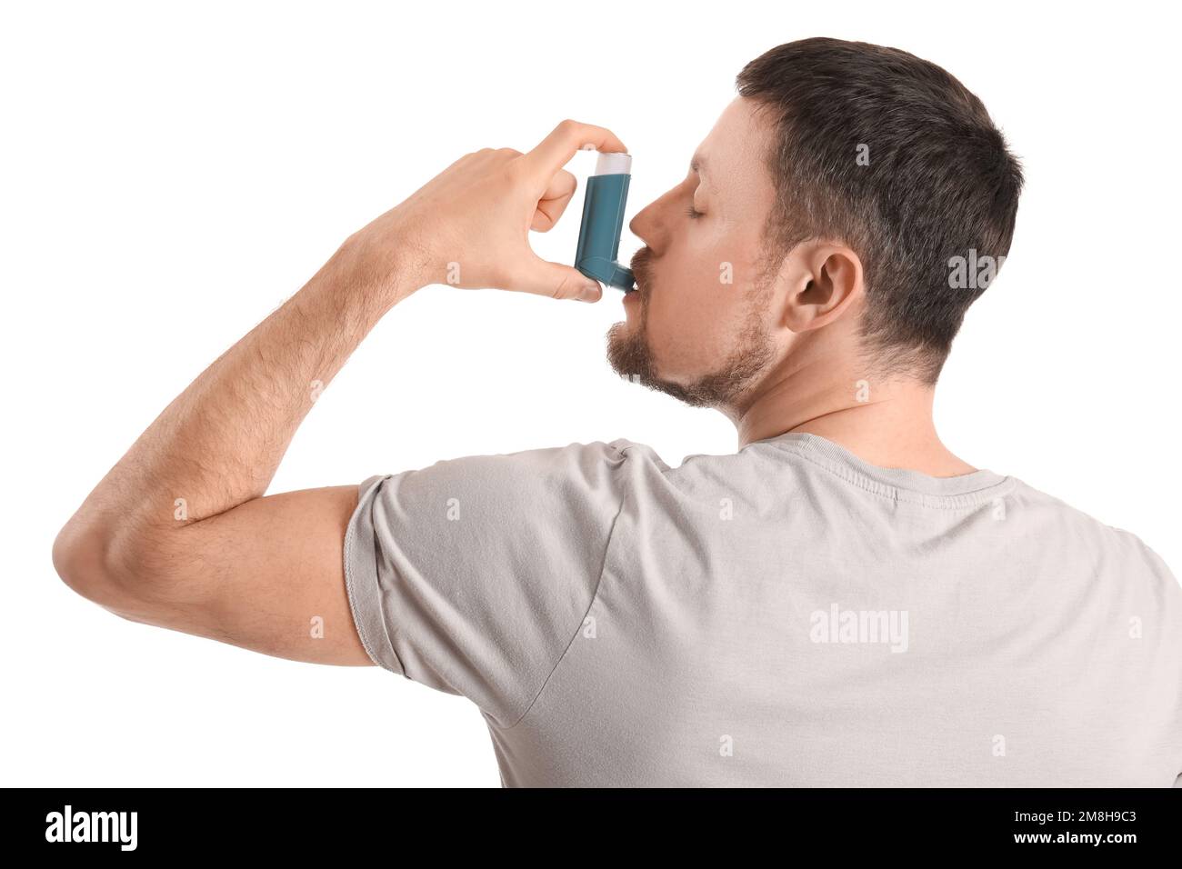 Man with inhaler on white background Stock Photo - Alamy